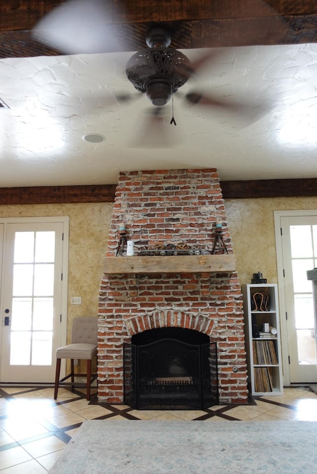 7840 Halliday St, Beaumont, TX 77706 - unfurnished living room featuring tile patterned flooring, a ceiling fan, and a brick fireplace