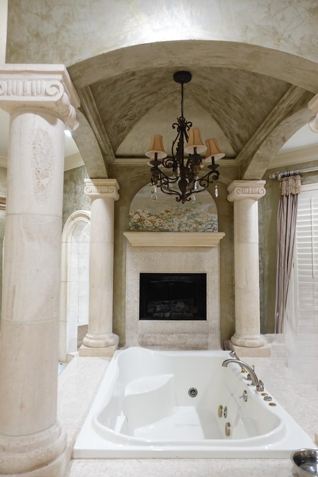 7840 Halliday St, Beaumont, TX 77706 - bathroom featuring decorative columns, a chandelier, a jetted tub, crown molding, and a high end fireplace