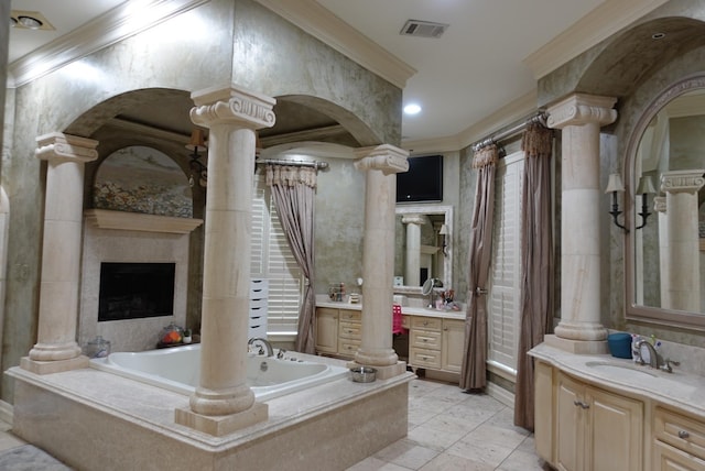 7840 Halliday St, Beaumont, TX 77706 - bathroom with decorative columns, crown molding, a garden tub, two vanities, and a fireplace