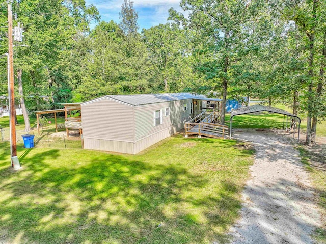 exterior space featuring a yard and a carport