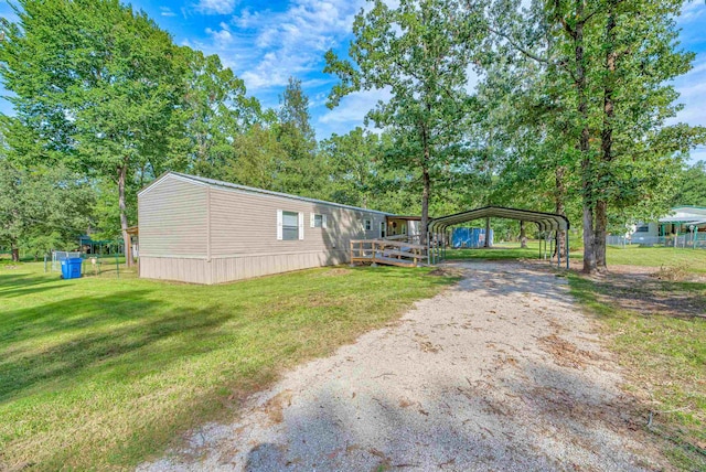 view of front of property with a carport and a front lawn