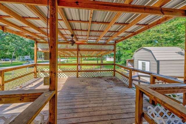 wooden terrace featuring a storage unit