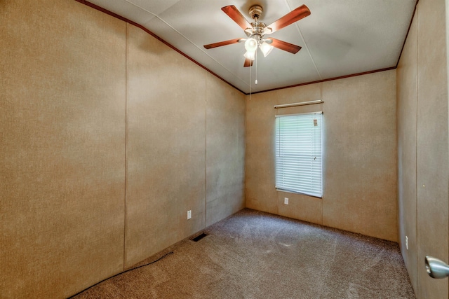 carpeted empty room with crown molding and ceiling fan