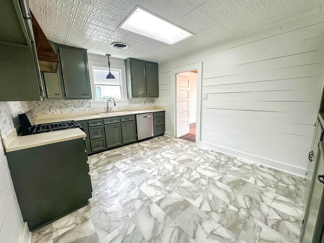 kitchen featuring pendant lighting, stainless steel dishwasher, range, and sink