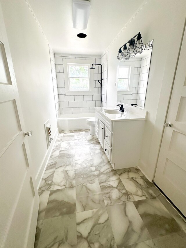 full bathroom with vanity, toilet, and tiled shower / bath