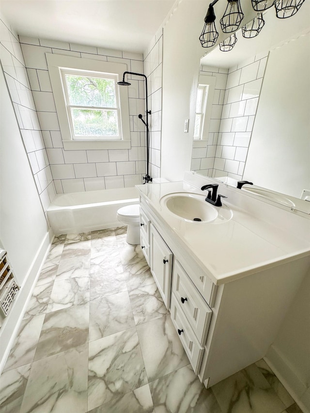 full bathroom with vanity, toilet, and tiled shower / bath