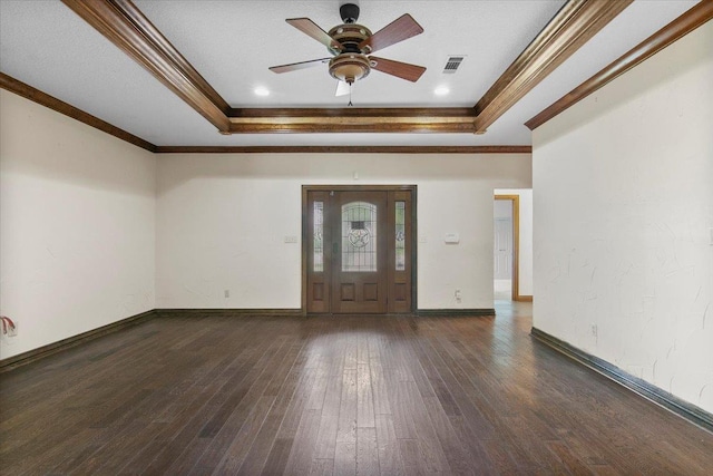 foyer with a tray ceiling, crown molding, and dark hardwood / wood-style floors