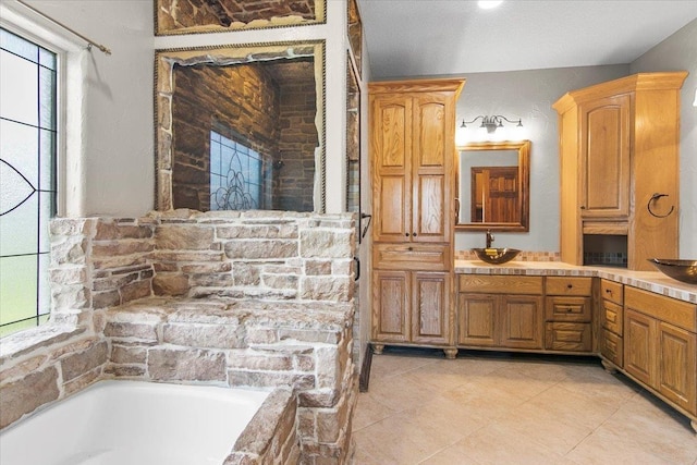 bathroom featuring vanity and tiled bath