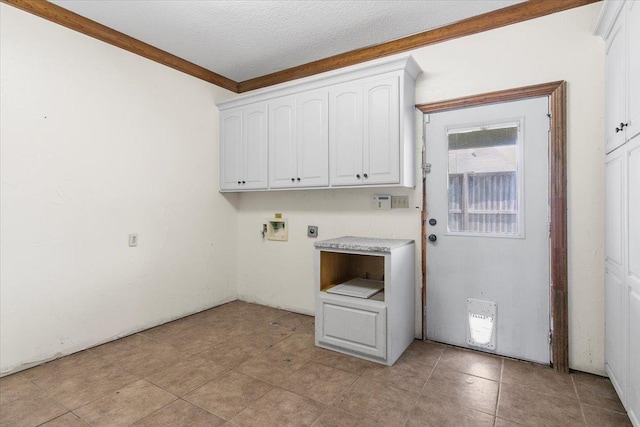 washroom with electric dryer hookup, hookup for a washing machine, cabinets, and a textured ceiling