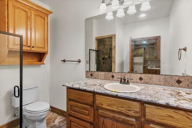 bathroom with an enclosed shower, vanity, toilet, and tasteful backsplash