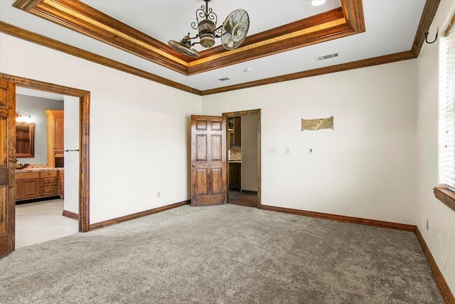 unfurnished bedroom featuring carpet flooring, ensuite bathroom, and ornamental molding