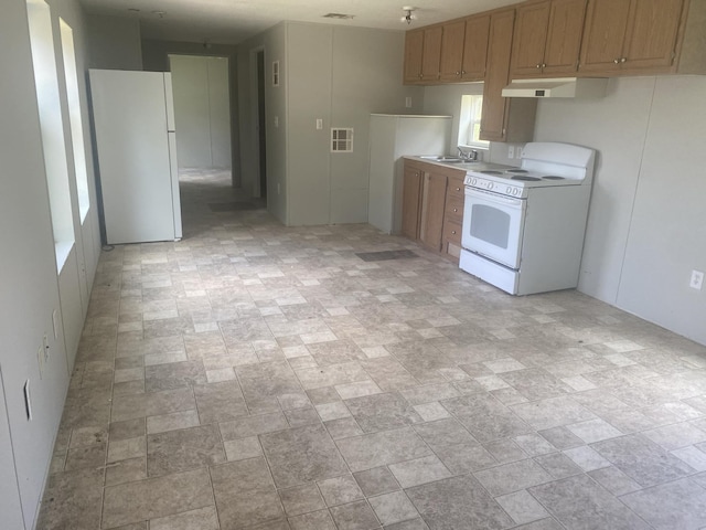8185 Fm 1122, Silsbee, TX 77656 - kitchen featuring white appliances, range hood, a sink, and light countertops