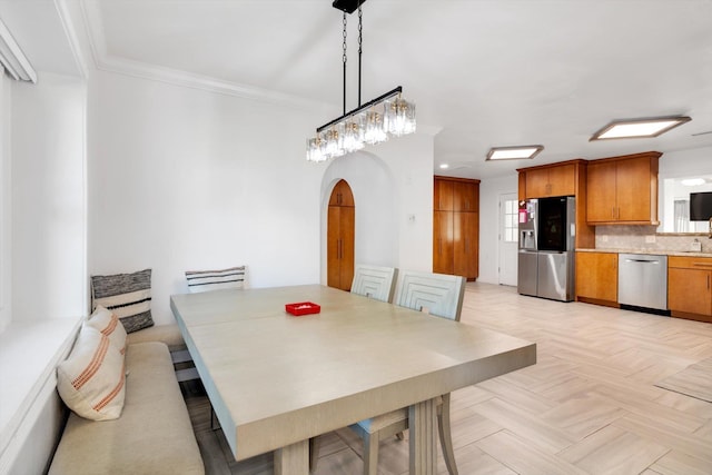 dining area with light parquet floors and ornamental molding