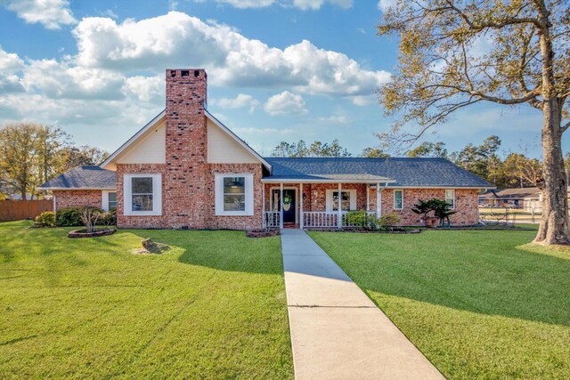 view of front facade with covered porch and a front yard