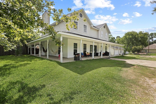 503 Country Wood Cir, Sour Lake, TX 77659 - back of property with a yard, a patio area, and a chimney