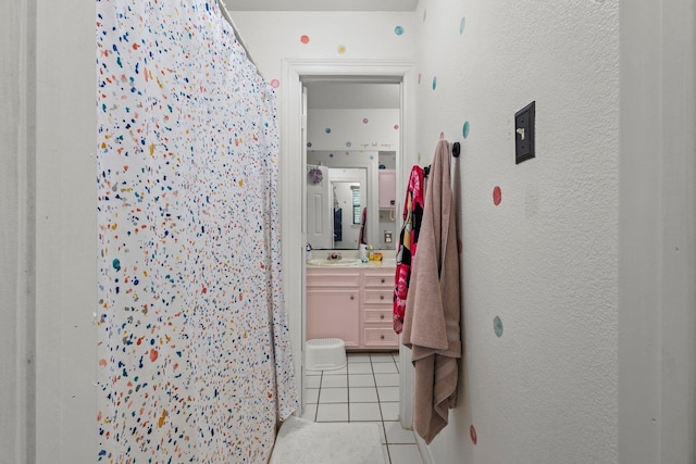 503 Country Wood Cir, Sour Lake, TX 77659 - bathroom with tile patterned floors, vanity, a shower with curtain, and a textured wall