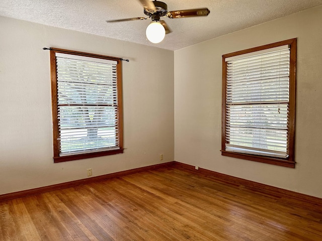 empty room featuring hardwood / wood-style floors, a textured ceiling, and ceiling fan