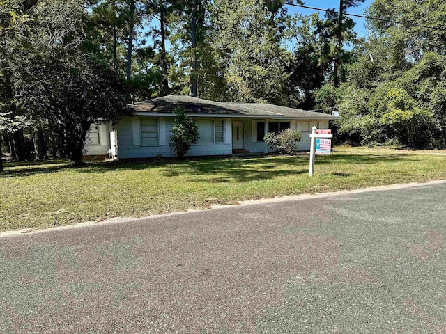 ranch-style home with a front lawn