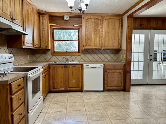 kitchen featuring french doors, sink, a chandelier, a textured ceiling, and white appliances