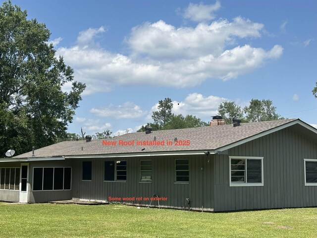 3605 Lawn Oak Dr, Orange, TX 77632 - back of house with roof with shingles, a lawn, a chimney, and a sunroom