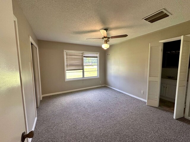 3605 Lawn Oak Dr, Orange, TX 77632 - unfurnished bedroom featuring carpet flooring, a textured ceiling, baseboards, and ceiling fan
