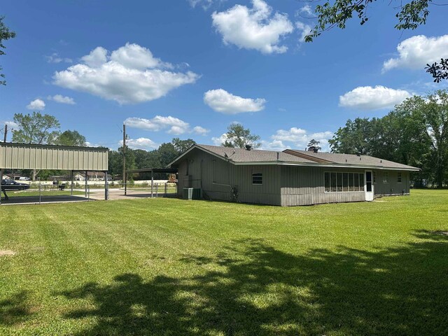 3605 Lawn Oak Dr, Orange, TX 77632 - view of home's exterior featuring a lawn, central AC unit, and a carport