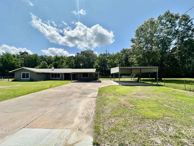 3605 Lawn Oak Dr, Orange, TX 77632 - view of front of property with concrete driveway, view of scattered trees, and a carport