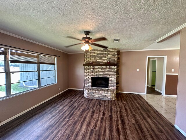 3605 Lawn Oak Dr, Orange, TX 77632 - unfurnished living room with ceiling fan, a brick fireplace, wood finished floors, ornamental molding, and baseboards