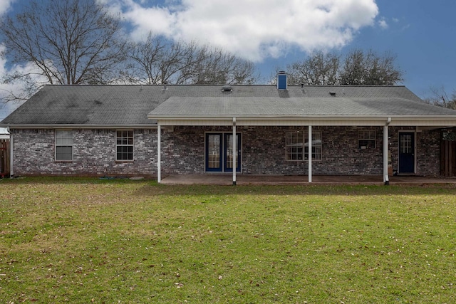 back of house featuring a yard and a patio