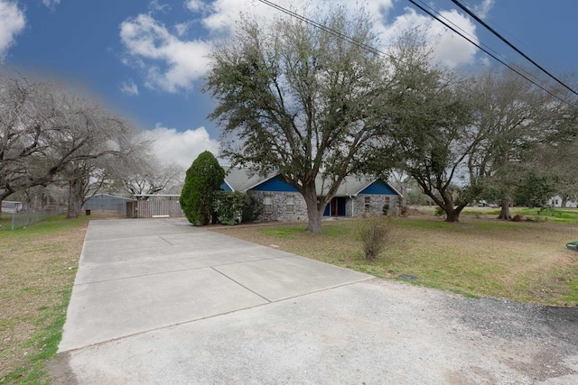 obstructed view of property with a front yard