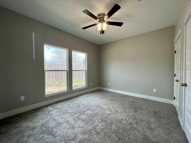 carpeted empty room featuring ceiling fan