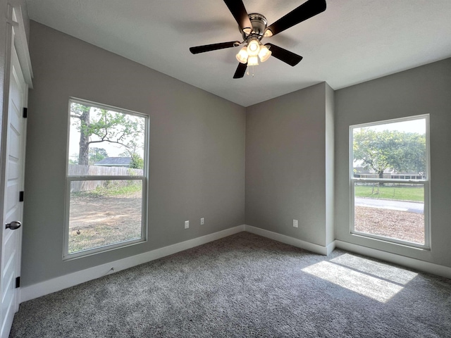 carpeted empty room featuring ceiling fan