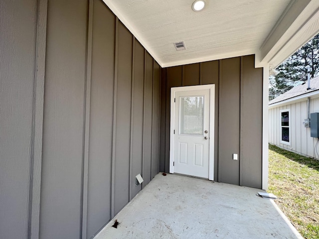 view of exterior entry featuring a patio