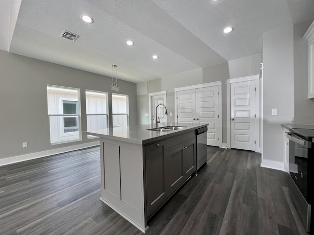 kitchen with pendant lighting, sink, gray cabinets, stainless steel appliances, and a center island with sink