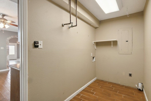 laundry room featuring ceiling fan, electric dryer hookup, electric panel, hardwood / wood-style floors, and hookup for a washing machine