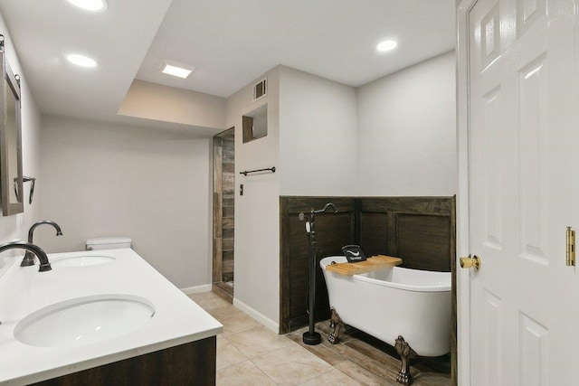 bathroom with tile patterned floors, vanity, and shower with separate bathtub