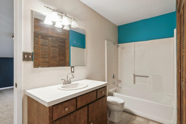 full bathroom featuring vanity, toilet, shower / bath combination, and a textured ceiling