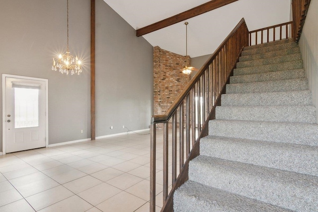 staircase featuring tile patterned flooring, beamed ceiling, high vaulted ceiling, and an inviting chandelier