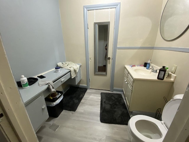 3600 Main Ave, Groves, TX 77619 - half bathroom with toilet, vanity, and wood finished floors