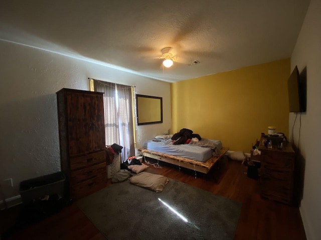 3600 Main Ave, Groves, TX 77619 - bedroom with wood finished floors, a textured wall, and ceiling fan