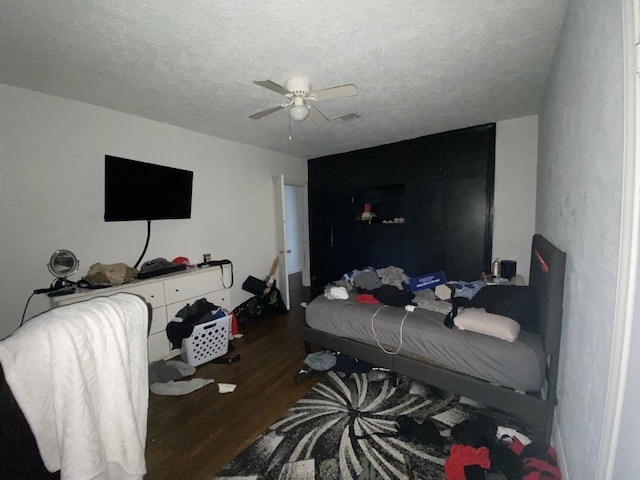3600 Main Ave, Groves, TX 77619 - bedroom with wood finished floors, a textured ceiling, and ceiling fan