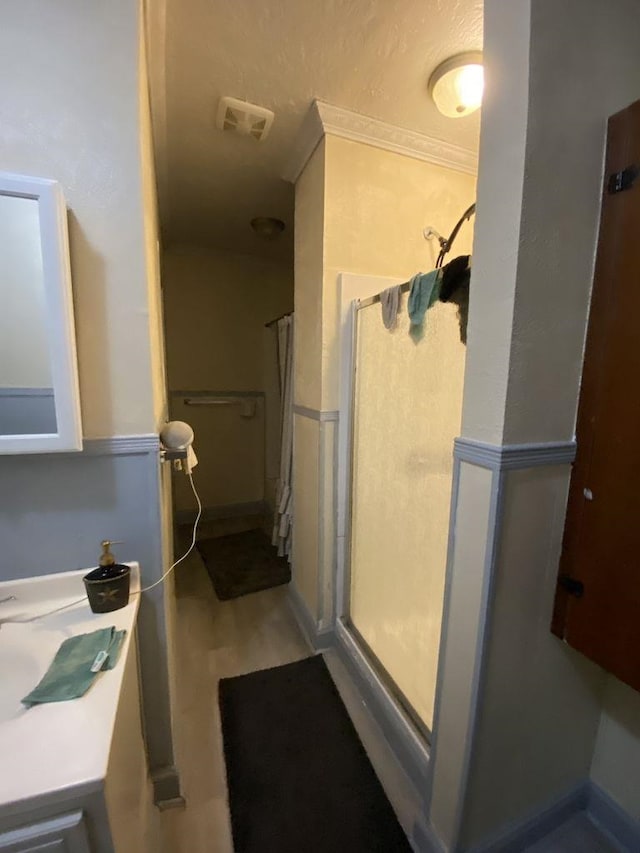 3600 Main Ave, Groves, TX 77619 - bathroom with a shower stall and wood finished floors