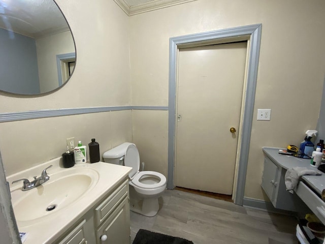 3600 Main Ave, Groves, TX 77619 - bathroom featuring vanity, crown molding, toilet, and wood finished floors