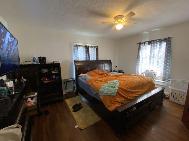 3600 Main Ave, Groves, TX 77619 - bedroom featuring dark wood finished floors, a textured ceiling, ceiling fan, and baseboards