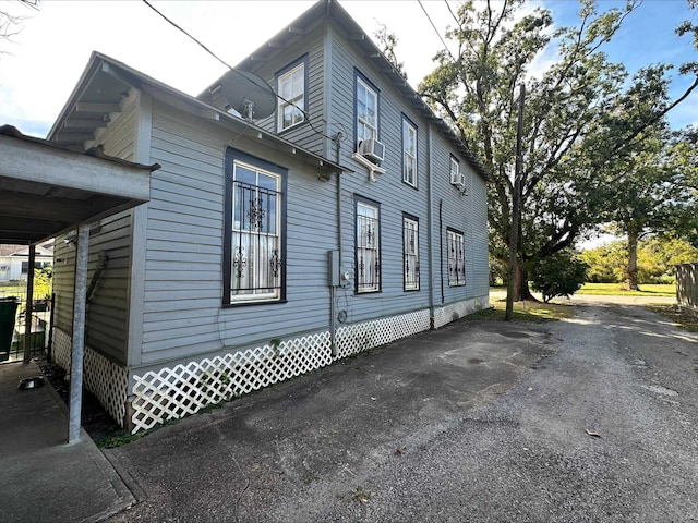 view of side of home featuring cooling unit