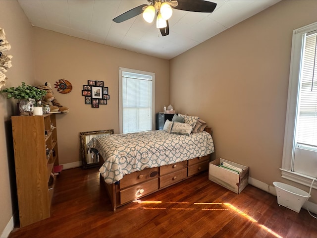 bedroom with ceiling fan and dark hardwood / wood-style floors