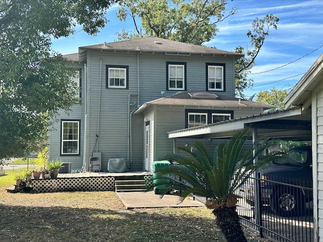 rear view of house featuring a wooden deck