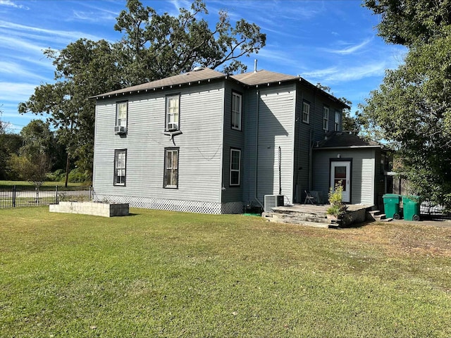 exterior space with a lawn and central AC