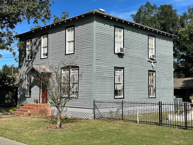 view of property exterior with a lawn and cooling unit