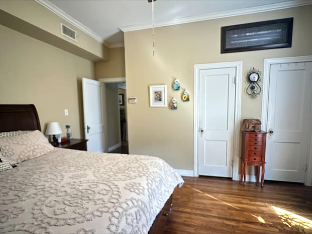 bedroom featuring dark hardwood / wood-style flooring and ornamental molding